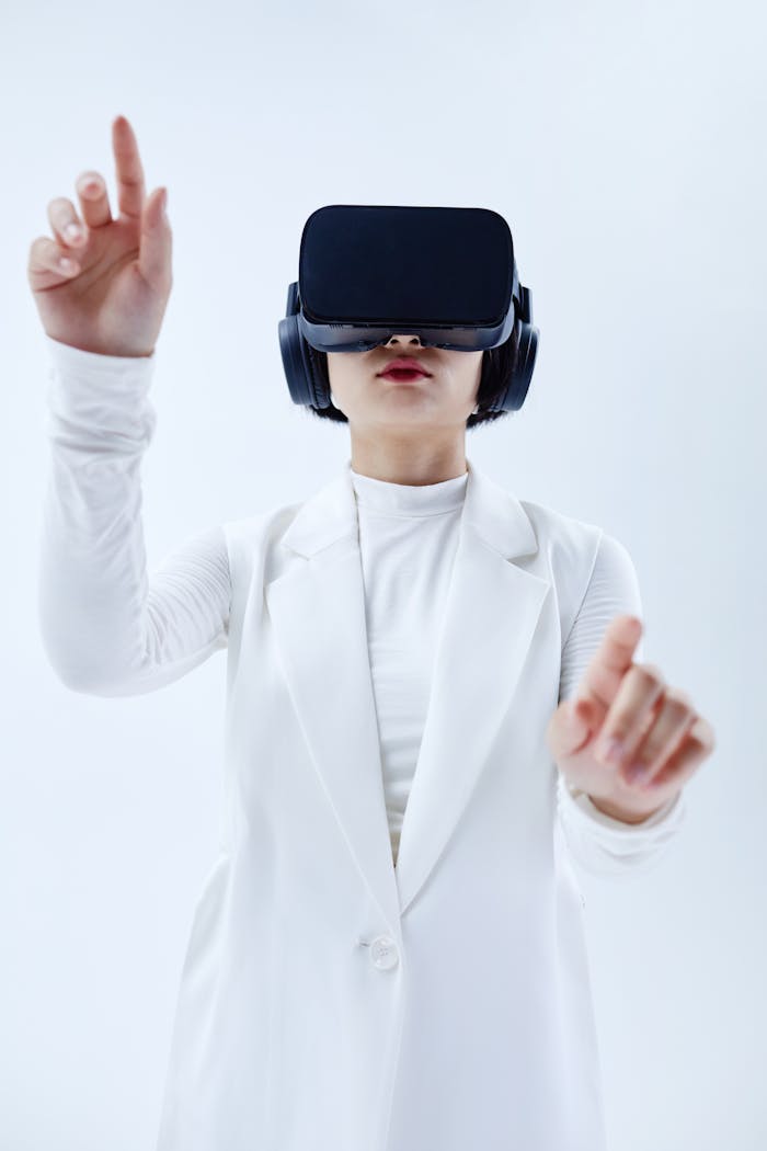 Woman in White Suit Wearing Black VR Glasses